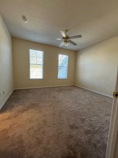 2646 Southwest 87 Way Gainesville, FL 32608 - Photo 13 of 19 an empty room with windows and ceiling fan view