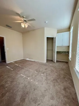 a view of an empty room with a kitchen