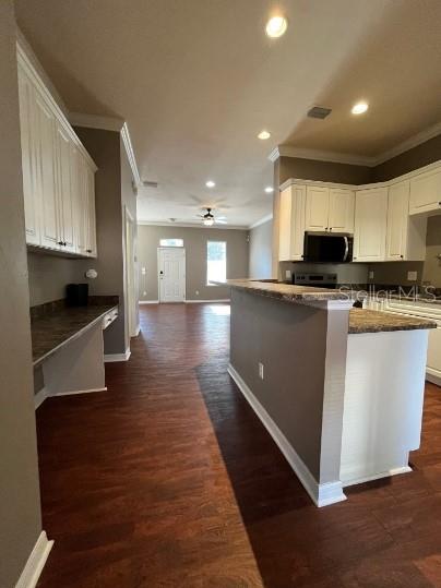 2646 Southwest 87 Way Gainesville, FL 32608 - Photo 4 of 19 a kitchen with stainless steel appliances granite countertop a stove a sink and a refrigerator