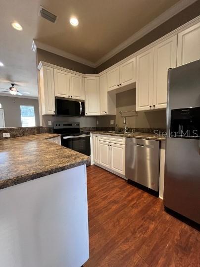 2646 Southwest 87 Way Gainesville, FL 32608 - Photo 5 of 19 a kitchen with stainless steel appliances granite countertop a sink a stove top oven a counter space and cabinets