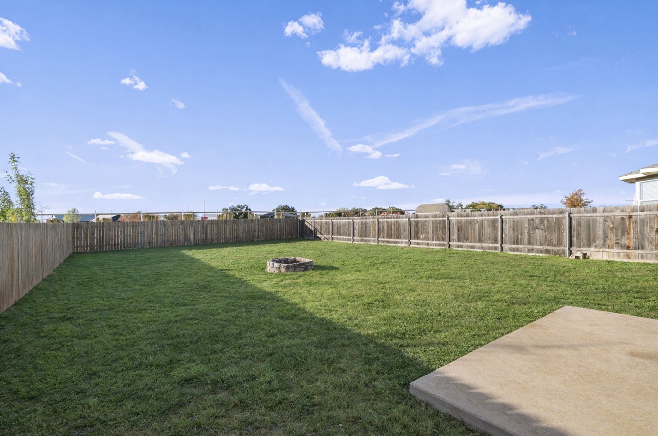 313 Drystone Trail Liberty Hill, TX 78642 - Photo 17 of 17 Fenced backyard with a fire pit and a patio
