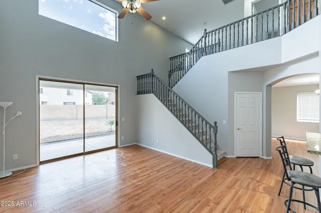 a view of a hallway with wooden floor and stairs