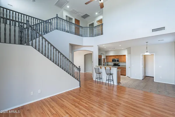 a view of a hallway with dining room and wooden floor