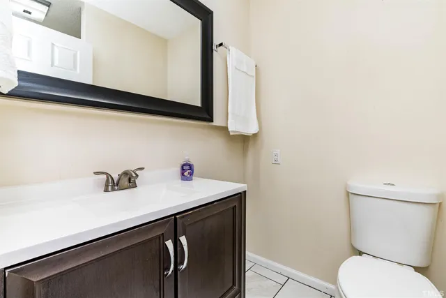 a bathroom with a sink a toilet and mirror