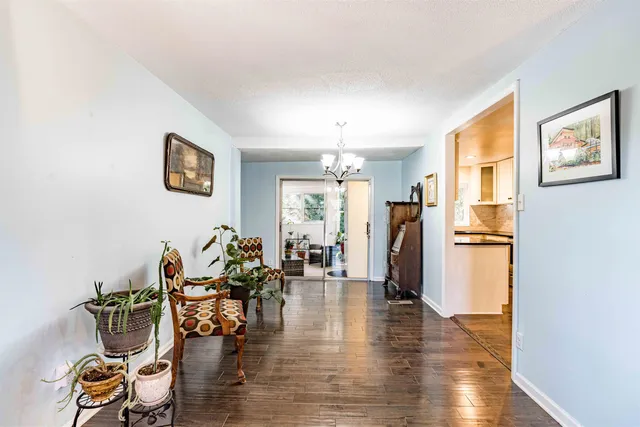 a living room with furniture or couch and a chandelier