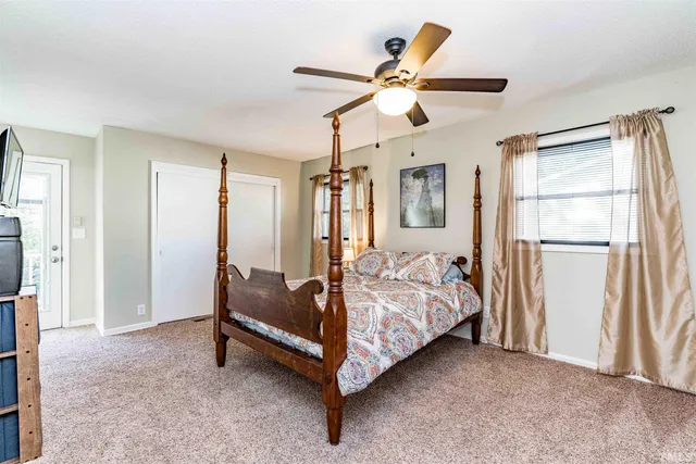 a bed room with a bed and a chandelier