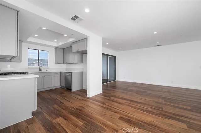 a kitchen with wooden floors and white appliances