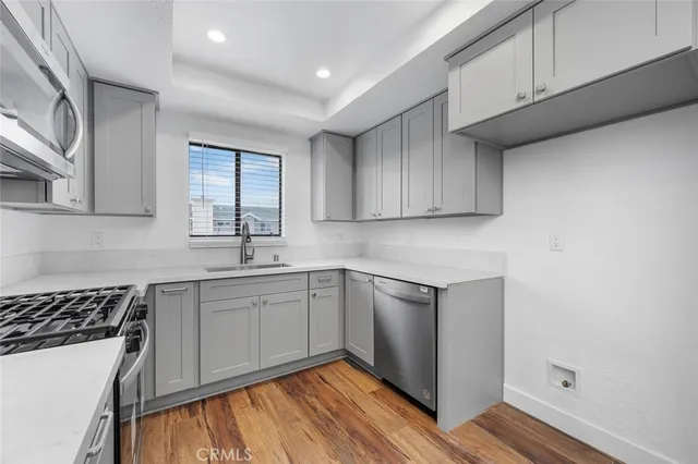 a kitchen with a sink stove and cabinets