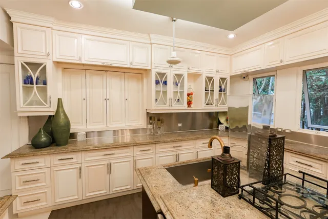 a kitchen with a dining table and chairs