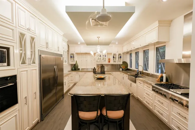 a kitchen with sink stove and cabinets