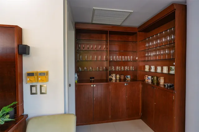a living room with furniture a flat screen tv and a large window