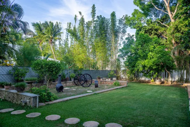 a spacious bedroom with a bed and a flat screen tv