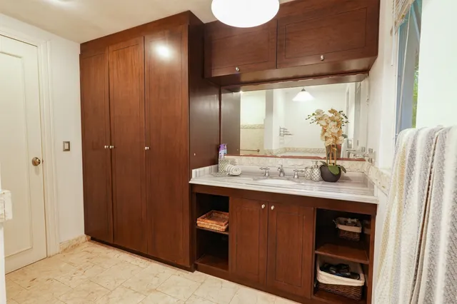 a bathroom with a sink toilet and mirror