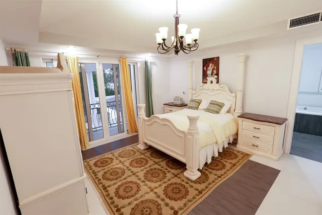 a bedroom with furniture and a large window