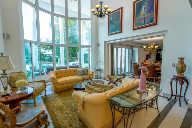 a living room with furniture a fireplace and a chandelier