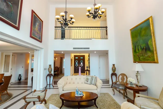 a living room with furniture a lamp and large window