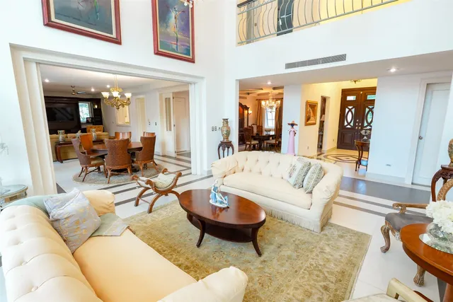 a dining room with furniture a chandelier and wooden floor