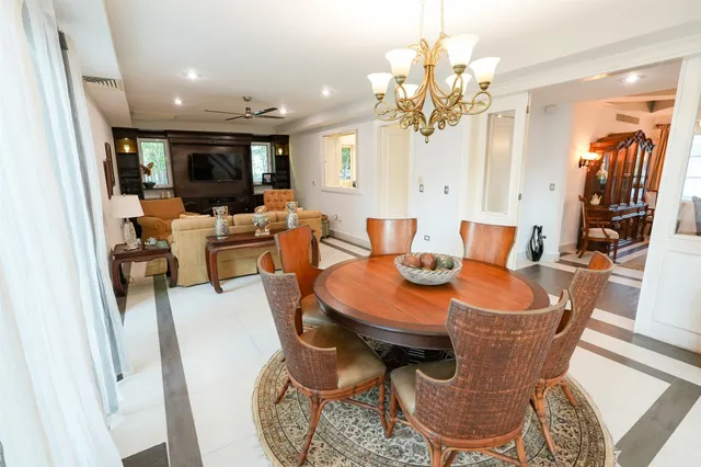 a living room with furniture a flat screen tv and a window