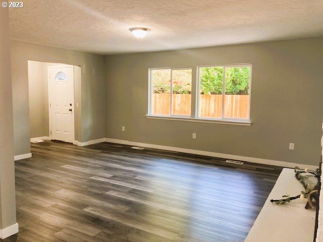 306 South Toutle Road Toutle, WA 98649 - Photo 18 of 36 an empty room with wooden floor and windows