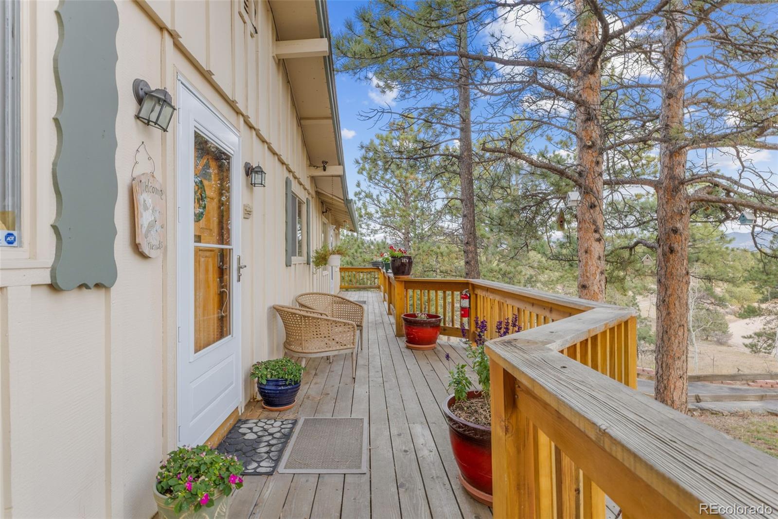 1995 Mockingbird Trail Bailey, CO 80421 - Photo 8 of 24 a balcony with wooden floor and outdoor seating