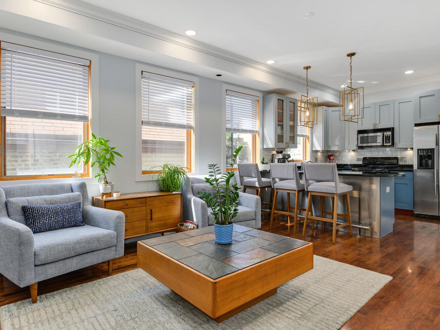 1834 West Rice Street, Unit C Chicago, IL 60622 - Photo 5 of 31 a living room with furniture a large window and a dining table