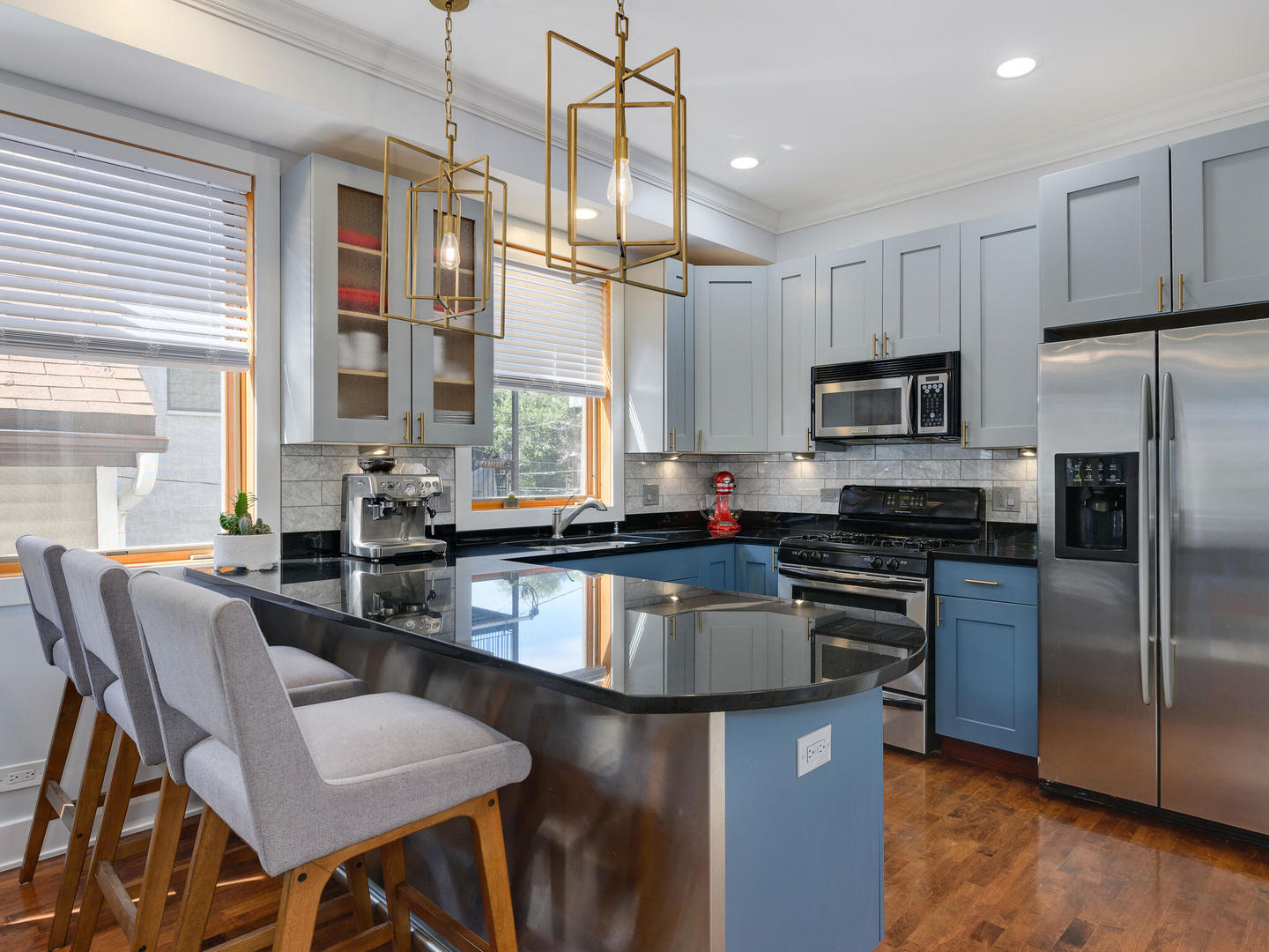 1834 West Rice Street, Unit C Chicago, IL 60622 - Photo 6 of 31 a kitchen with granite countertop a table chairs microwave and refrigerator