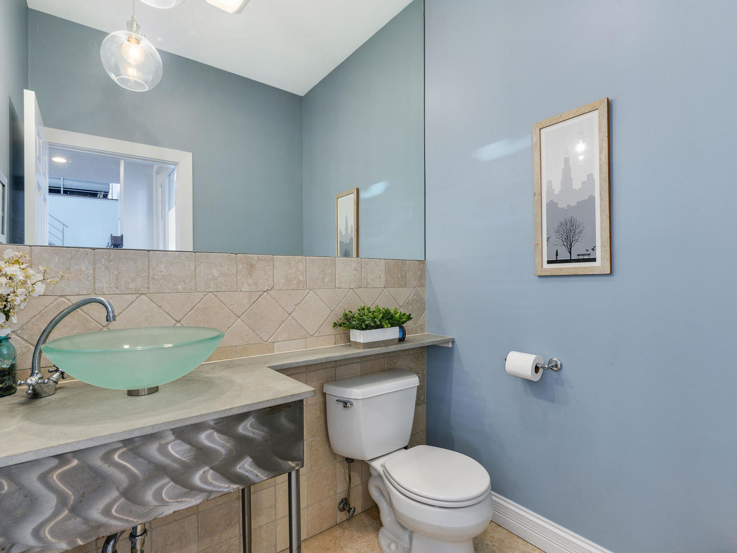 1834 West Rice Street, Unit C Chicago, IL 60622 - Photo 8 of 31 a bathroom with a granite countertop toilet a mirror and a sink
