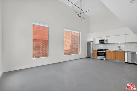 a view of a kitchen with furniture and windows