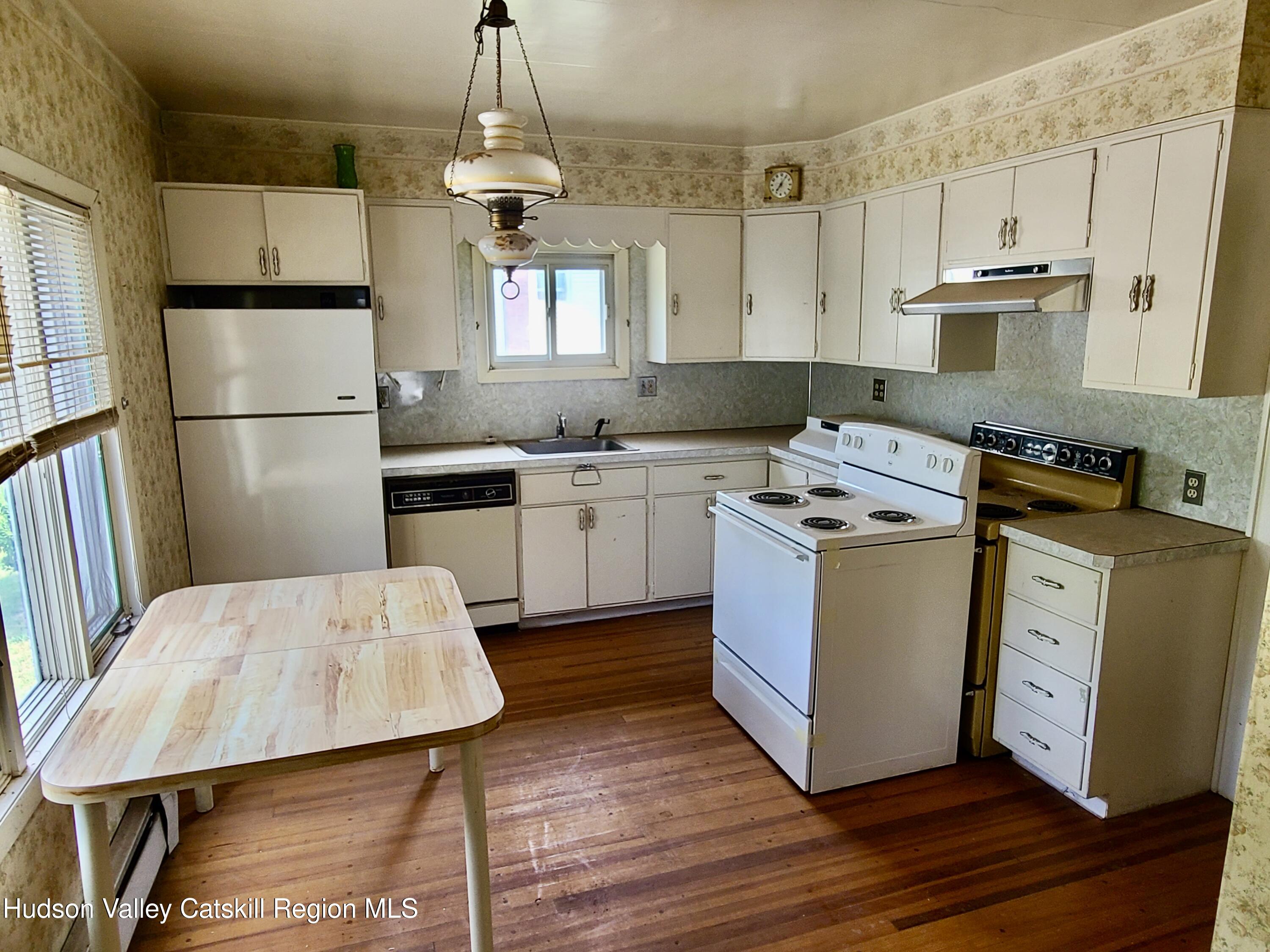 53200 Highway 30 Roxbury, NY 12421 - Photo 15 of 44 a kitchen with kitchen island a sink stove and refrigerator