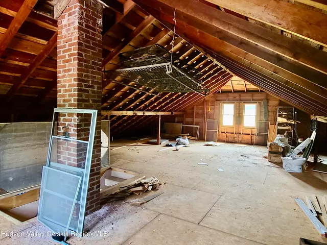 a view of a house with a yard and a tree