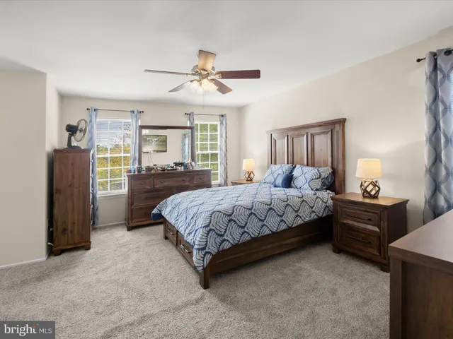 a bedroom with a bed dresser and a window