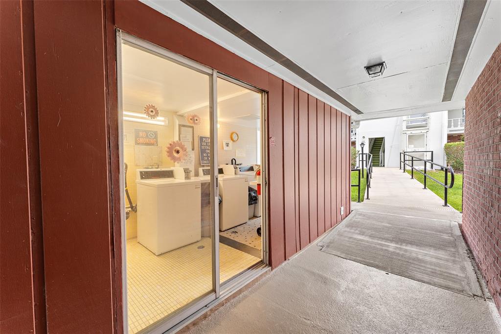 4746 Azalea Drive, Unit 105C New Port Richey, FL 34652 - Photo 24 of 27 a view of a hallway with wooden floor and windows