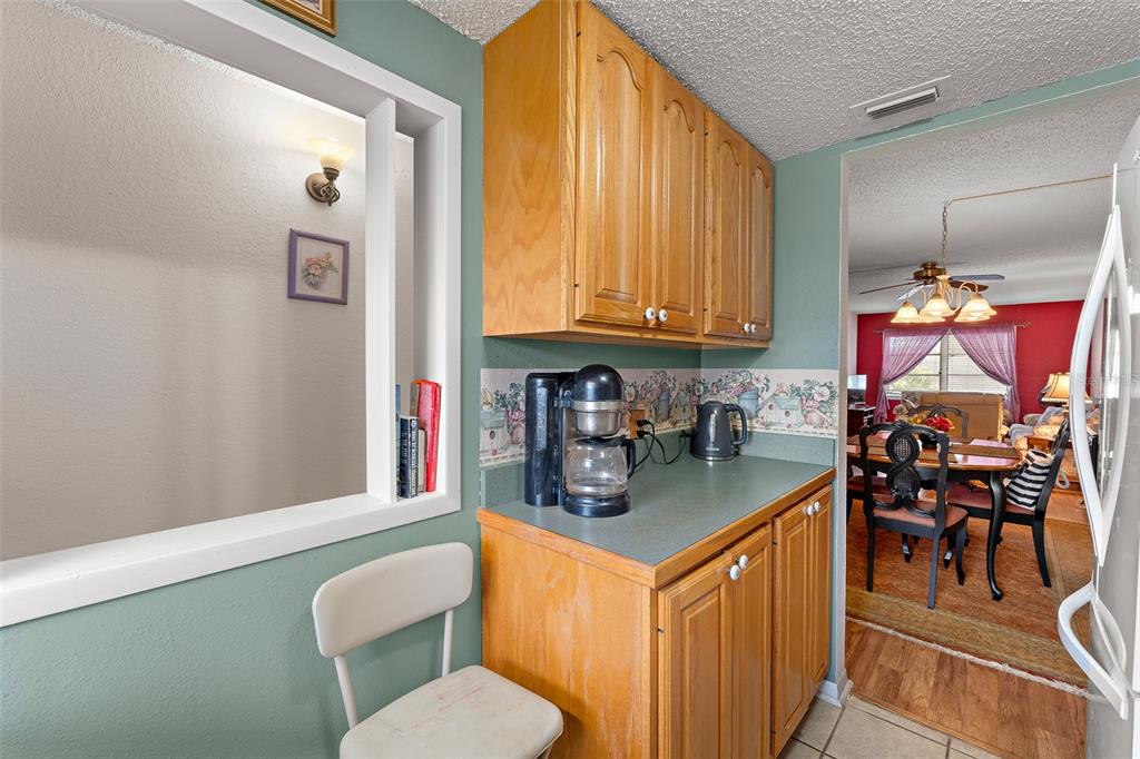 4746 Azalea Drive, Unit 105C New Port Richey, FL 34652 - Photo 7 of 27 a kitchen with stainless steel appliances granite countertop a sink stove and cabinets