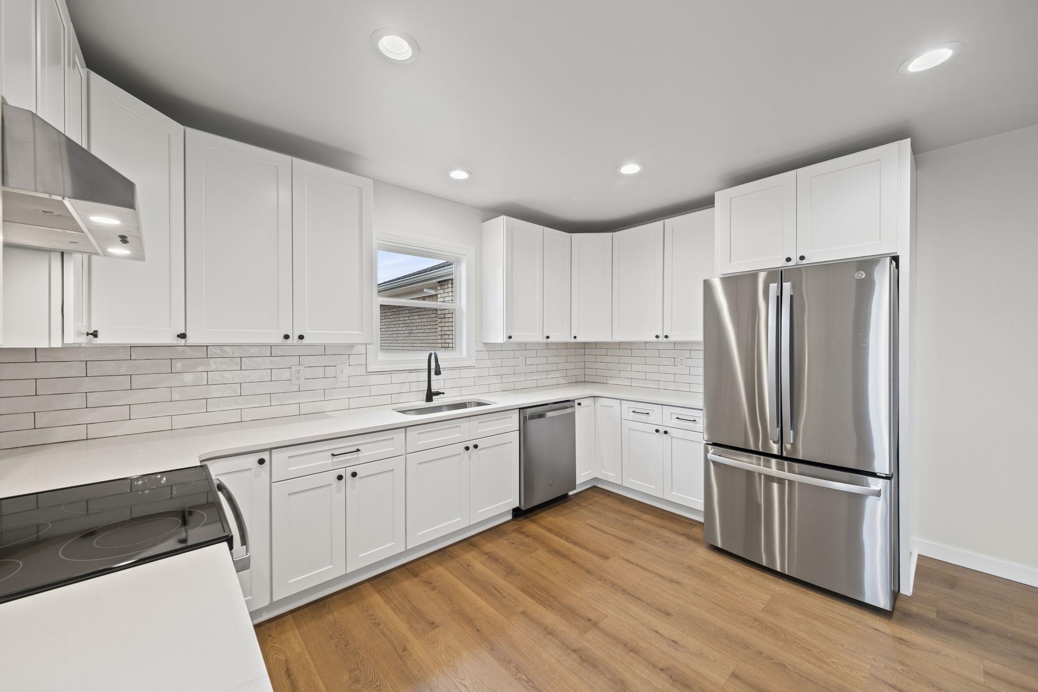 835 Curve Woodville Road Gates, TN 38037 - Photo 9 of 30 Kitchen featuring stainless steel appliances, white cabinets, light wood finished floors, and recessed lighting