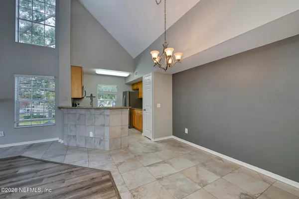 a kitchen with stainless steel appliances granite countertop sink stove refrigerator and cabinets
