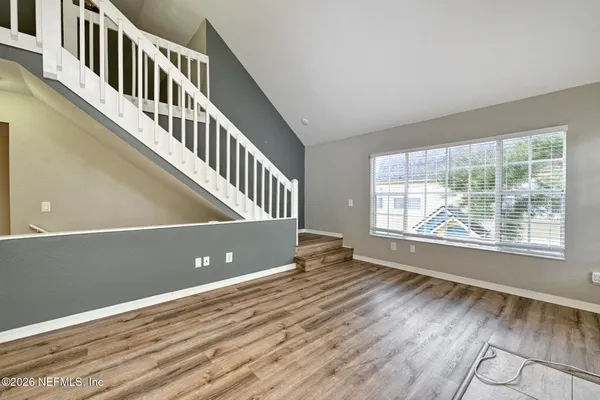 a view of a room with a fan and wooden floor