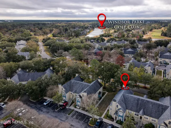 an aerial view of a houses with street