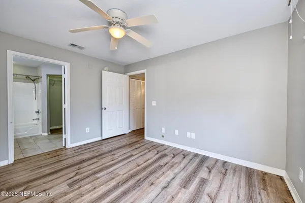a bathroom with a granite countertop sink mirror and a bath tub