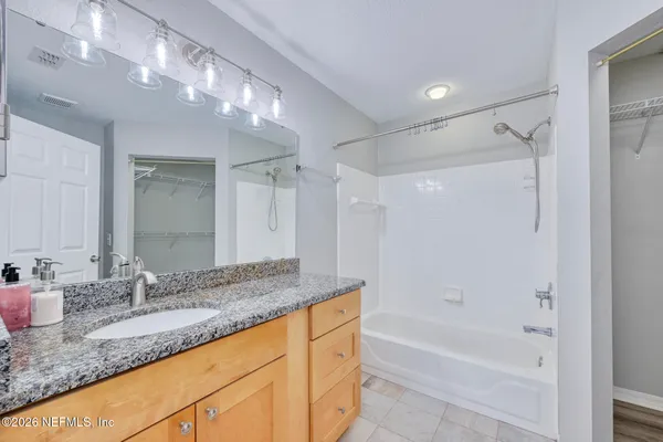 a bathroom with a glass shower door