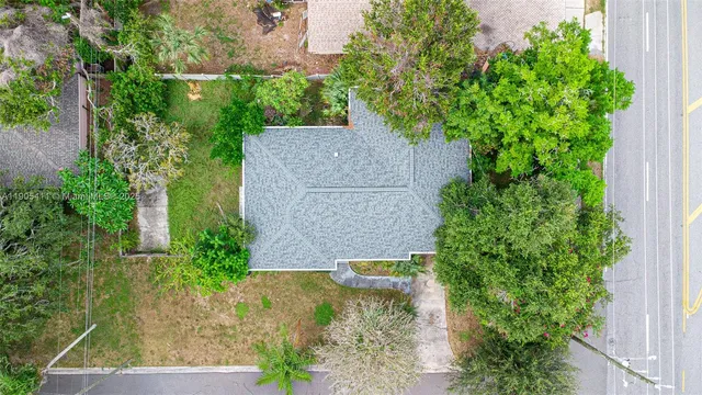 an aerial view of a house with a yard