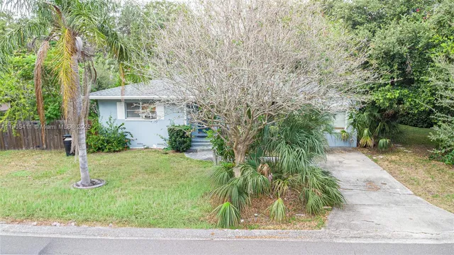 a view of backyard of house with green space