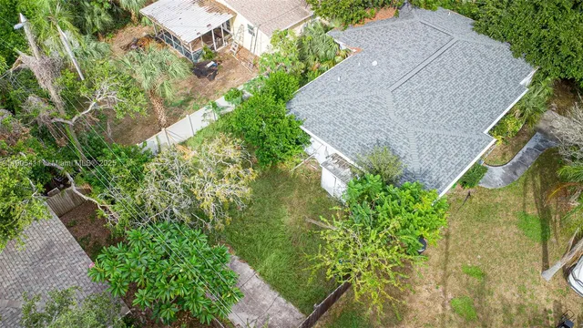 front view of a house with a yard and a trees