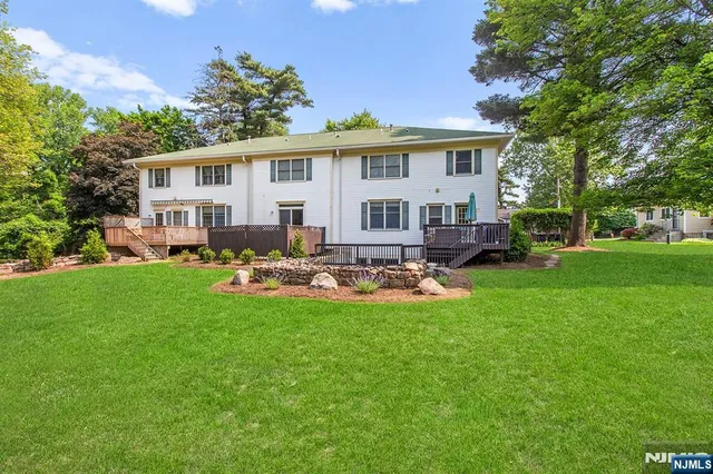 a view of a house with a backyard and a patio