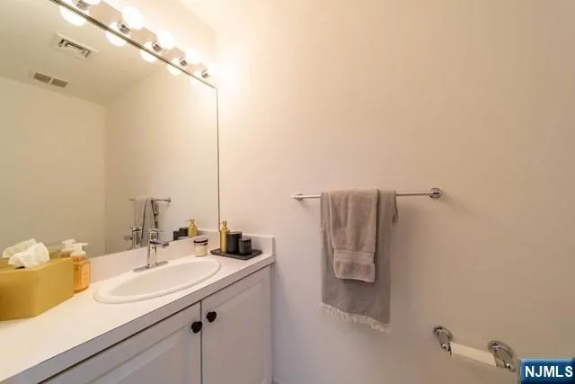 a bathroom with a sink and mirror