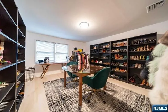 a living room with furniture a flat screen tv and a book shelf