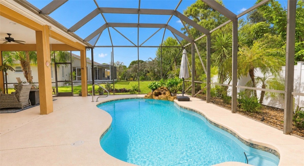 1771 Mistletoe Street Sebastian, FL 32958 - Photo 30 of 36 a swimming pool with outdoor seating and yard