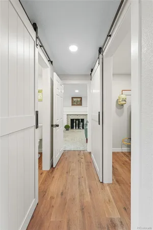 a view of a hallway with wooden floor and staircase