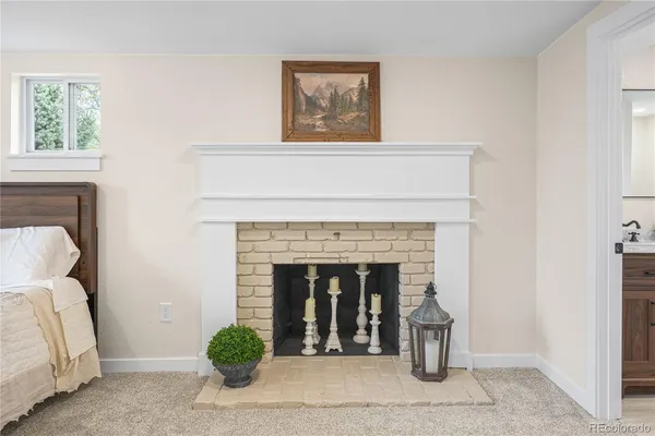a living room with a fireplace and a potted plant
