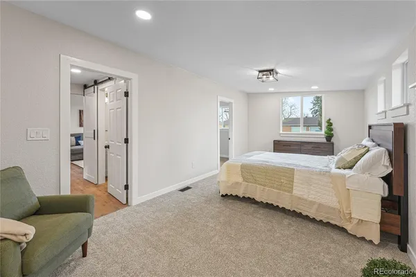 a spacious bedroom with a bed and a couch