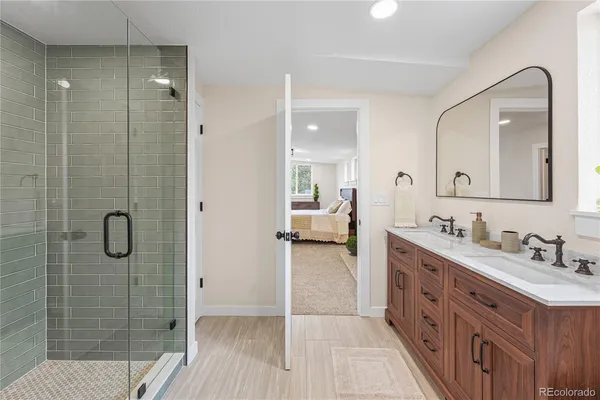 a bathroom with a double vanity sink mirror and shower